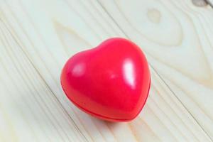 Red heart on wood background photo