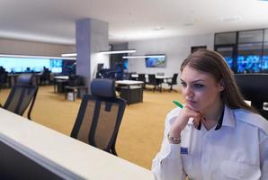 Female operator working in a security data system control room photo