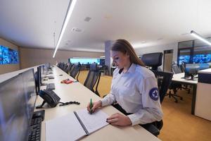 Woman operator working in a security data system control room photo