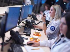 Female security guards working in a security data system control room photo