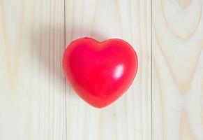 corazón rojo sobre fondo de madera foto