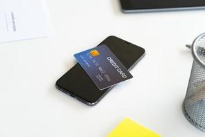 Smartphone with credit card on office desk,Online shopping concept photo