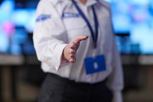 Female security operator extending a hand for a handshake photo