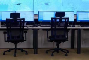 Empty interior of big modern security system control room photo