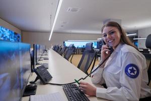 Female security guard operator talking on the phone photo