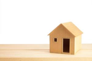 Toy wooden house model on white photo