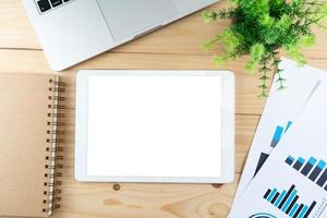 Office table top view and tablet with blank white screen photo