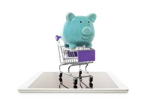 Piggy Bank in trolley shopping cart on white background.concept of savings online shopping photo