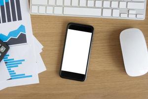 Office desk table with blank screen smart phone photo