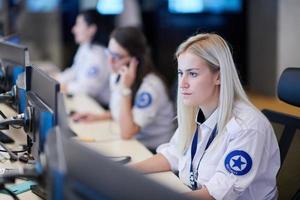 Female operator working in a security data system control room photo