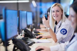 Female operator working in a security data system control room photo
