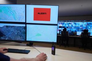 young male operator working in a security data system control room photo