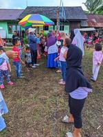 the excitement of adults and children taking part in a cracker eating competition to enliven the independence day of the republic of Indonesia, East Kalimantan, Indonesia August 13, 2022 photo