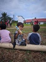 children playing together, east kalimantan, indonesia, august, 13,2022 photo