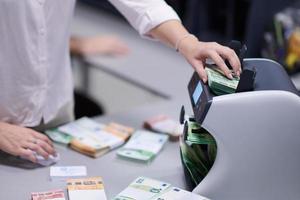 Bank employees sorting and counting paper banknotes photo