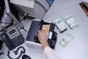 Bank employees sorting and counting paper banknotes photo