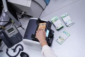 Bank employees sorting and counting paper banknotes photo