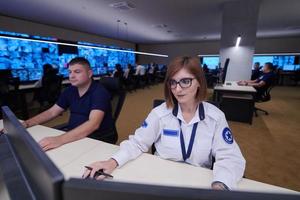 Female operator working in a security data system control room photo