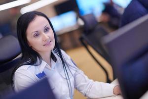 Female operator working in a security data system control room photo