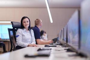 Female operator working in a security data system control room photo