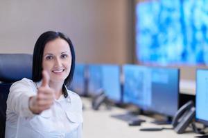 portrait of Female operator in a security data system control room photo