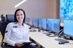 portrait of Female operator in a security data system control room photo