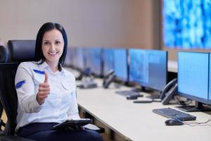 portrait of Female operator in a security data system control room photo