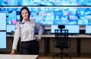 portrait of Female operator in a security data system control room photo