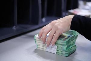 Bank employees sorting and counting paper banknotes photo