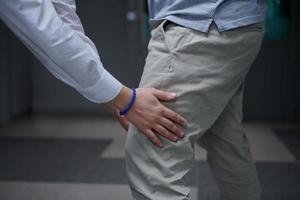 Security guard making body searching procedure on man photo