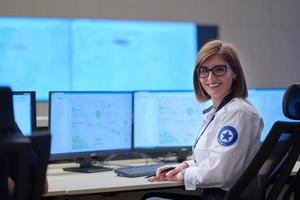 portrait of Female operator in a security data system control room photo