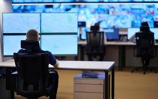 male operator working in a security data system control room photo