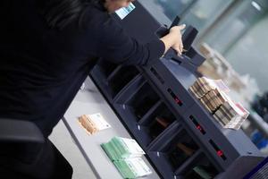 Bank employees sorting and counting paper banknotes photo