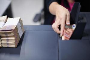 Bank employees sorting and counting paper banknotes photo