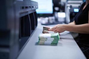 Bank employees sorting and counting paper banknotes photo