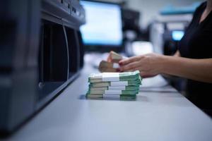 Bank employees sorting and counting paper banknotes photo