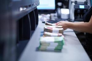 Bank employees sorting and counting paper banknotes photo