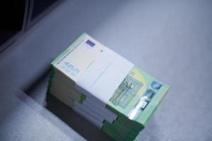 banknotes in front of electronic money counting machine photo