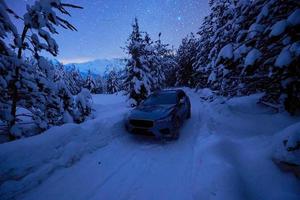 offroad suv car on icy winter north road photo