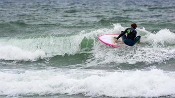 BUDE, CORNWALL, UK - AUGUST 13. Surfing at Bude in Cornwall on August 13, 2013. Unidentified person photo