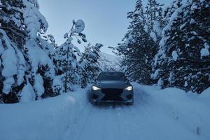 offroad suv car on icy winter north road photo