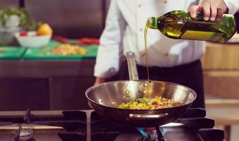 chef flipping vegetables in wok photo