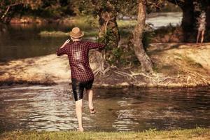 man jumping into the river photo