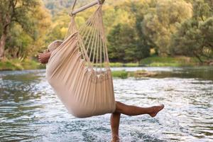 blonde woman resting on hammock photo