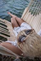 blonde woman resting on hammock photo