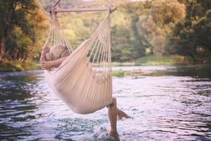 blonde woman resting on hammock photo