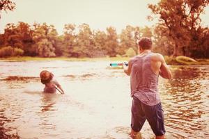 young men having fun with water guns photo