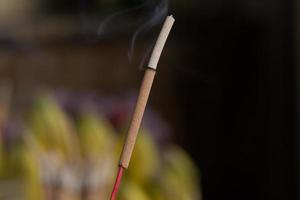 Incense stick and smoke from incense burning. photo