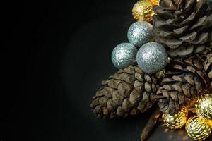 The christmas ball and Pine cones  on black  background. photo