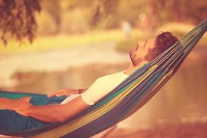 man resting on hammock photo